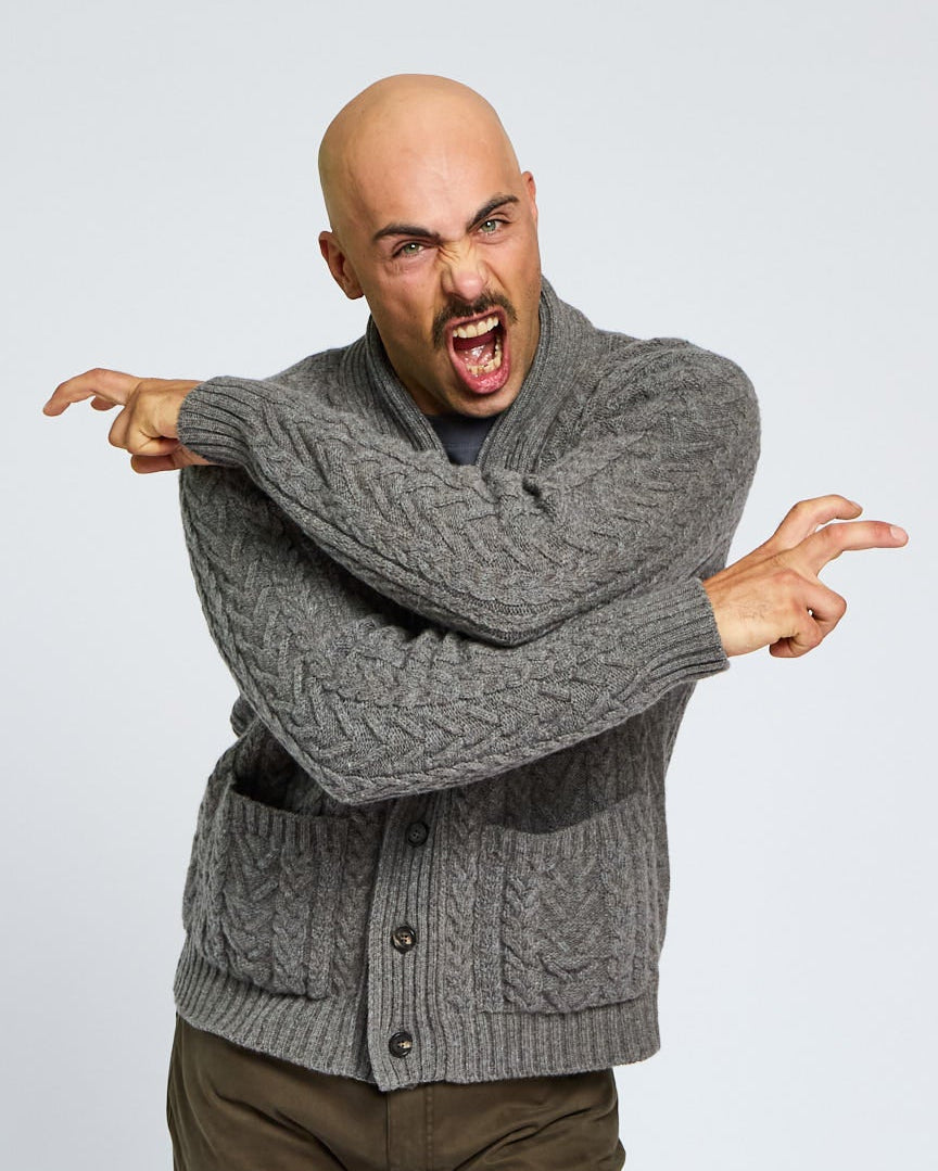 Man wearing a gray sweater on a light gray background