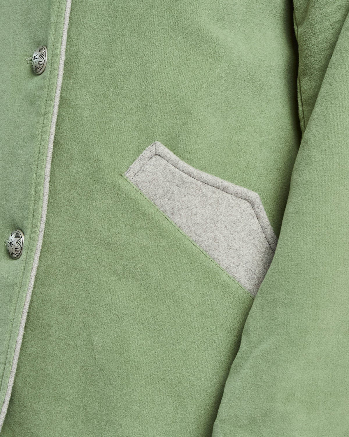 Close-up of a green jacket with a pocket on a white background