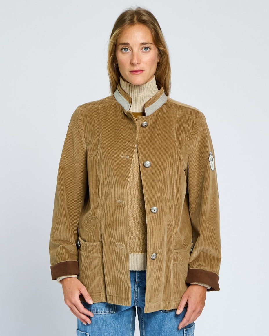 Woman wearing a brown jacket with a white background