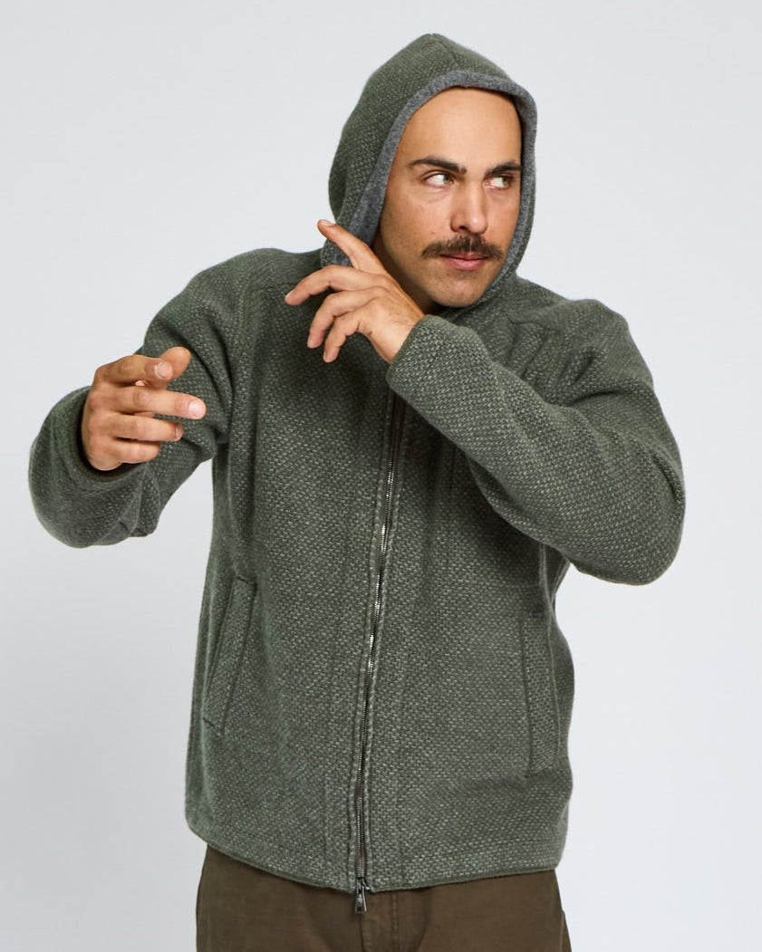 Man wearing a green hoodie on a white background