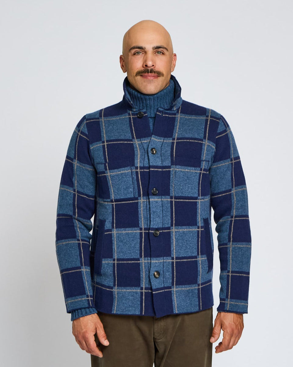 Man wearing a blue plaid jacket on a white background