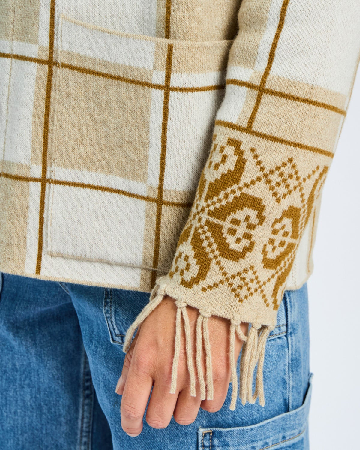 Plaid jacket with patterned sleeve and fringes on a plain background