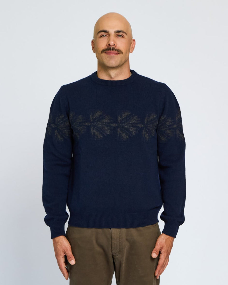 Man wearing a navy sweater with text on a plain background