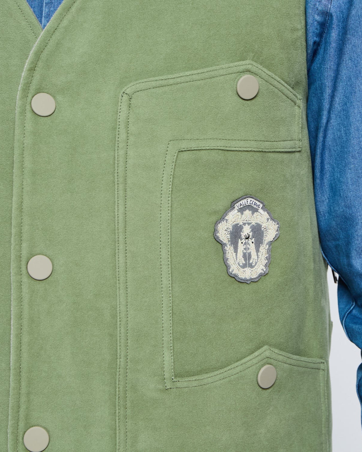 Green vest with a patch on a white background