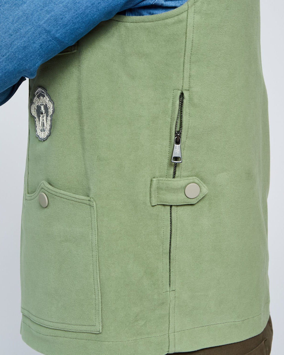 Green jacket with a patch and zipper on a white background