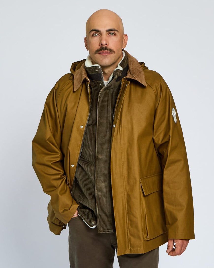 Man wearing a brown jacket on a white background
