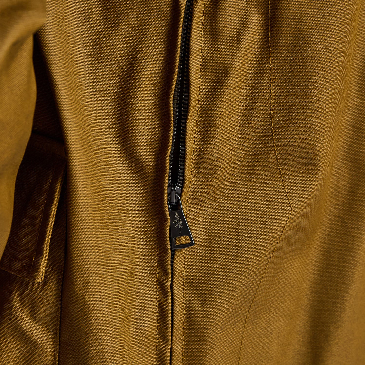 Close-up of a brown jacket with a zipper