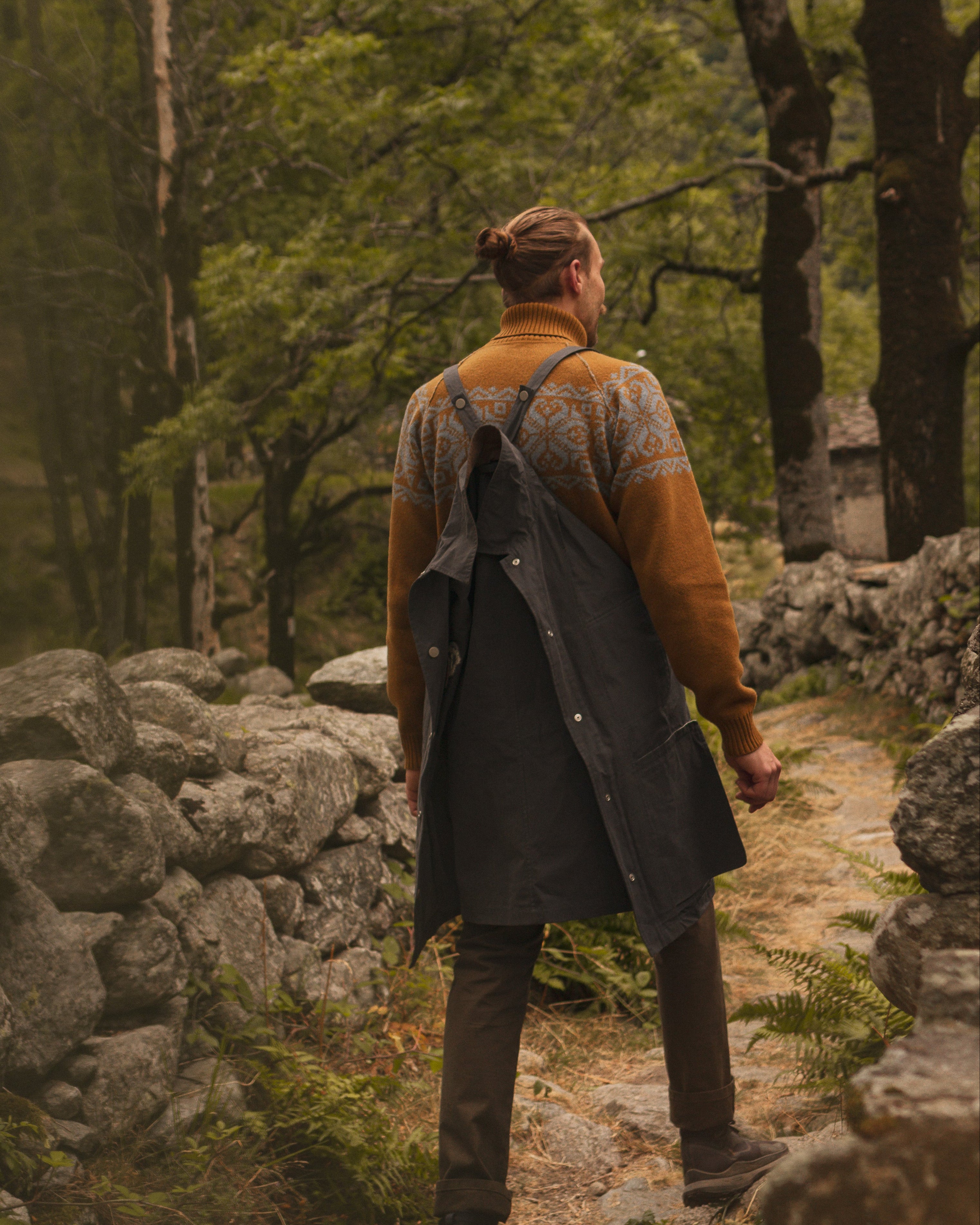 Person walking along a stone path in a forest
