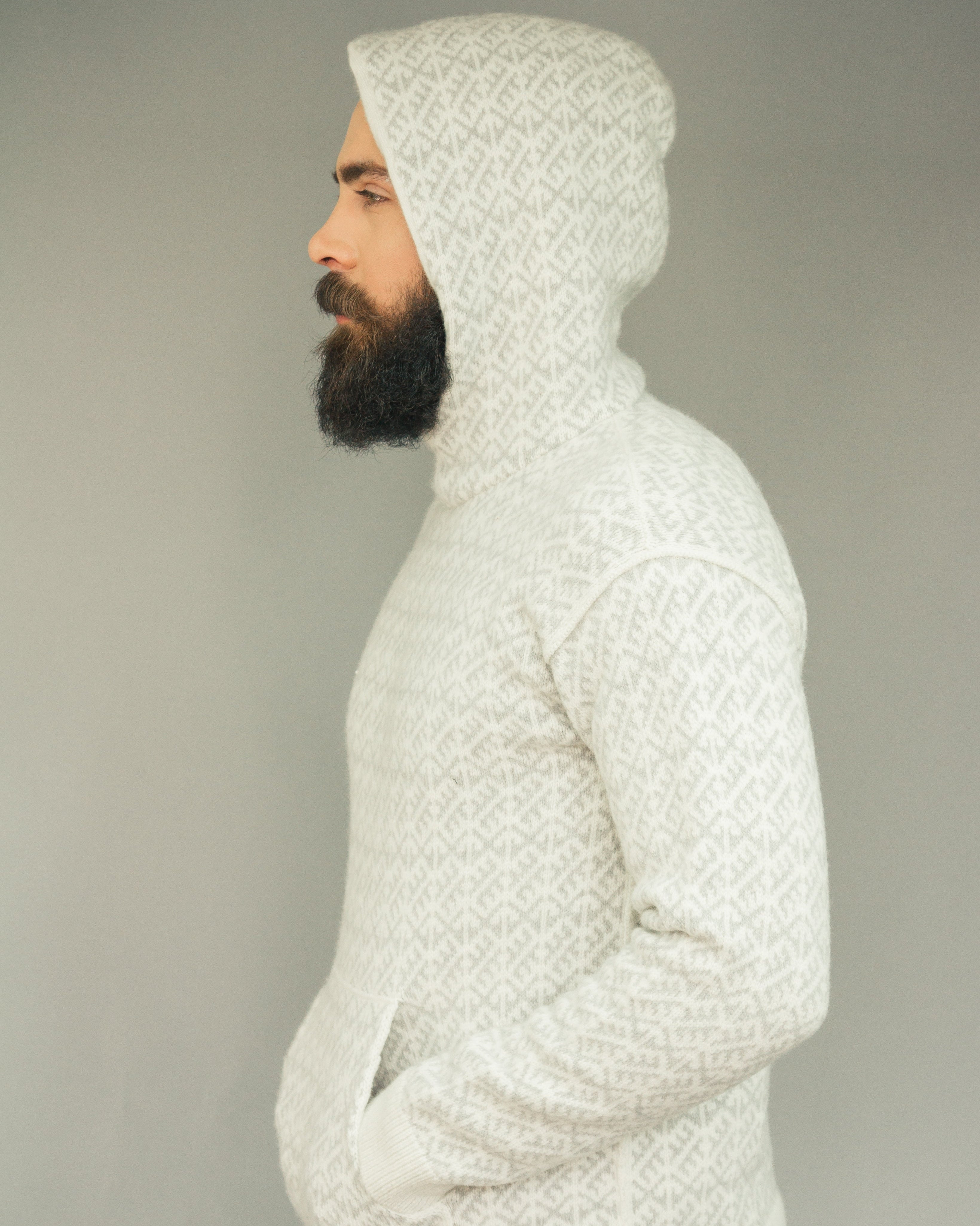 Person wearing a textured white hoodie against a plain background