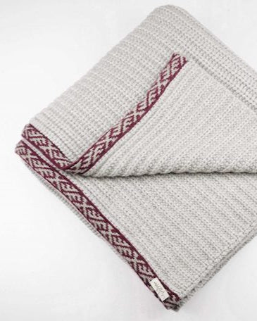 Wool Blanket | Sustainable |Nature | Cruelty-free outerwear | White and Red | Still life | Product shot