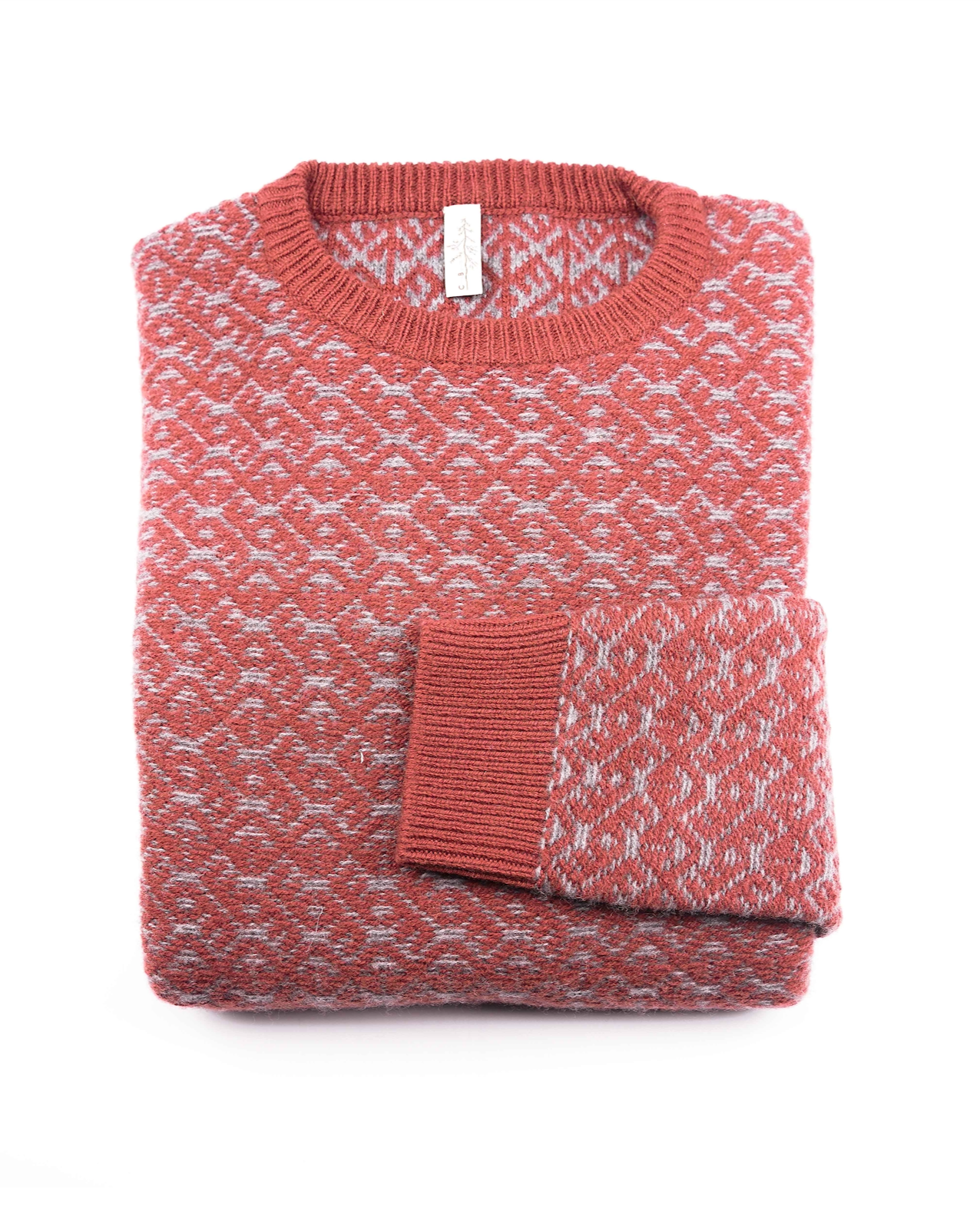 A folded Cima Bianca NIK Wool Crewneck Sweater with intarsia, in red and gray 100% wool, ribbed neckline and cuffs, is displayed on a white background with one sleeve neatly folded over the front.